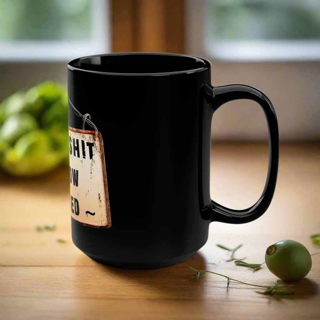 Black mug with a humorous label on a white background