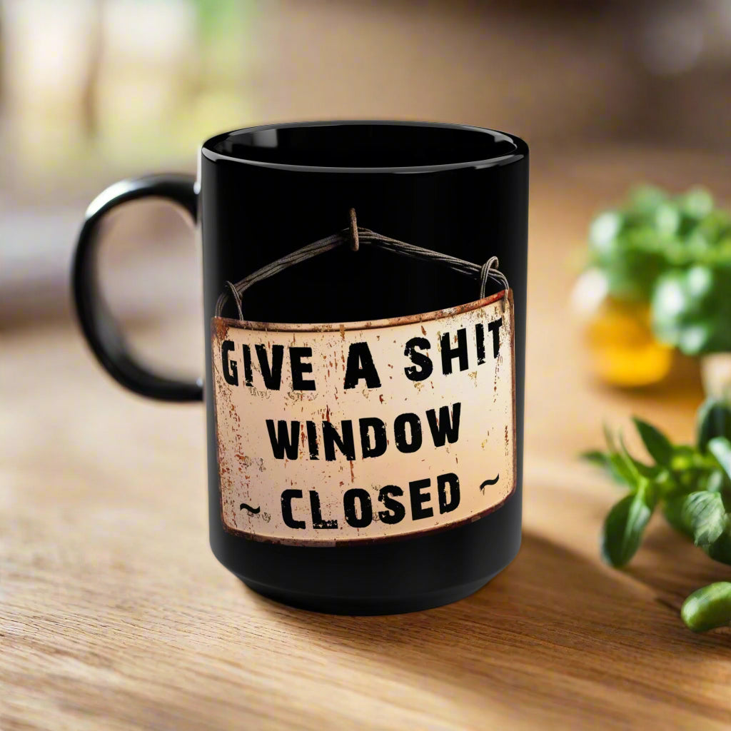 Black mug with a humorous label on a white background