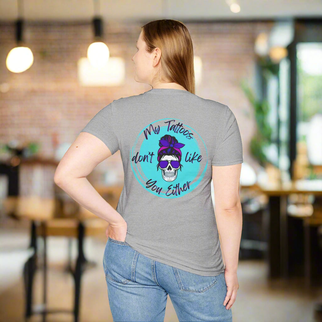 Person wearing a gray t-shirt with a colorful graphic and text on the back.