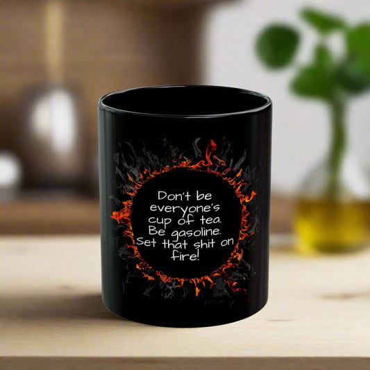 Black mug with flame design and text on a white background