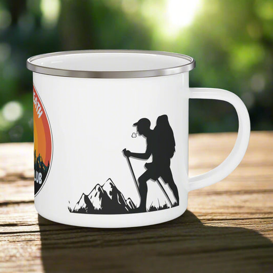 White mug with hiking design featuring a silhouette of a hiker and mountains on a white background.